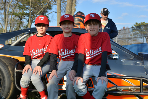 Nats players posing with a racecar. (Credit: Melanie Drozd)