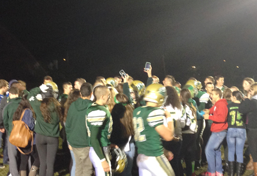 McGann-Mercy students celebrated with the players on the field following Friday night's playoff-clinching win. (Credit: Joe Werkmeister)