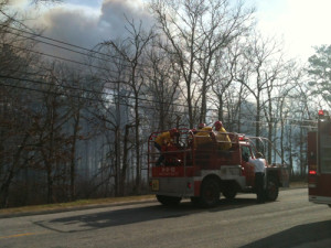 PAUL SQUIRE PHOTO | Riverhead firefighters rush into action on a brush truck during April's Manorville wildfire.