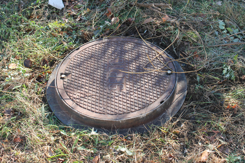 PAUL SQUIRE PHOTO | A Riverhead High School student fell into this septic well Friday morning. PAUL SQUIRE PHOTO | A Riverhead High School student fell into this septic well Friday morning.