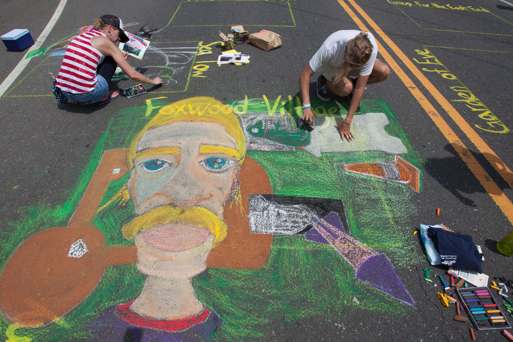 Luke Merz of Babylon works on his design while Elena Gayler of Hampton Bays paints in the background.