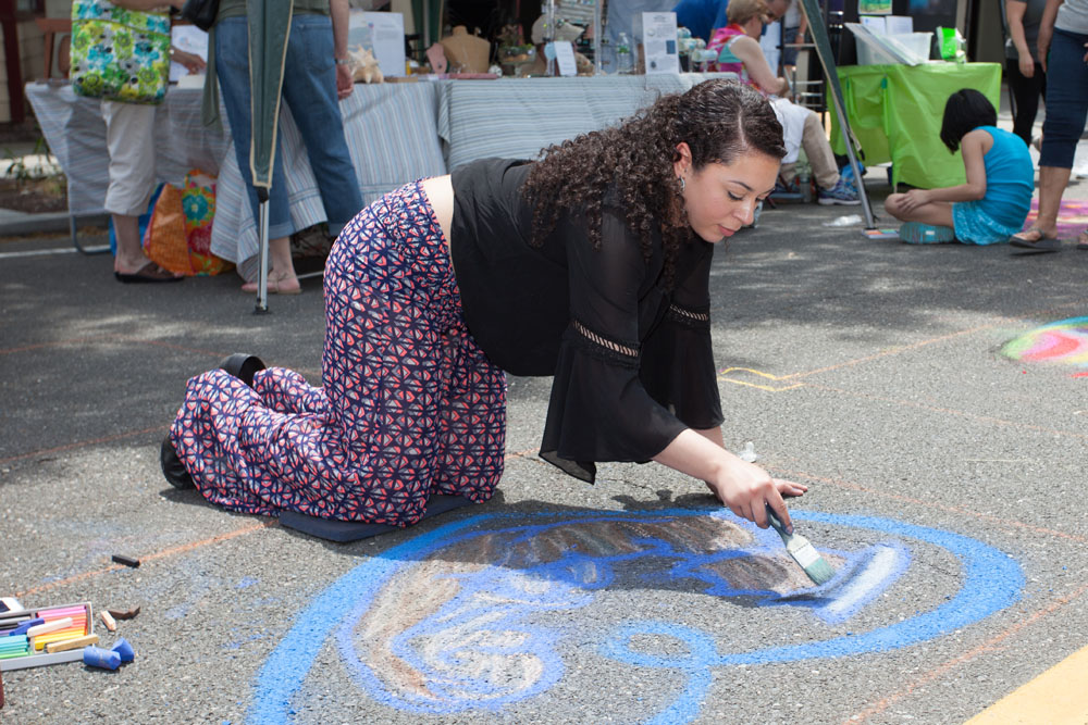 Brooke Ward-Adams of Center Moriches paints a Marine holding a baby.