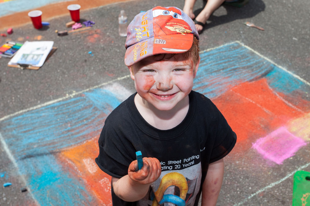 Dillon Realander, 4, of Riverhead has as much chalk on his face as he does on the street.
