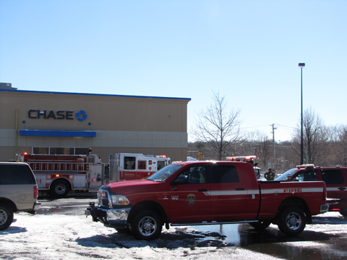 Firefighters briefly evacuated a bank after a fuel spill outside of it this afternoon. (Credit: Tim Gannon)