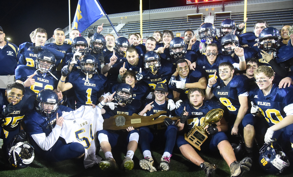 The Shoreham-Wading River football team celebrates its 2014 Long Island Championship win over Roosevelt. (Credit: Robert O'Rourk)