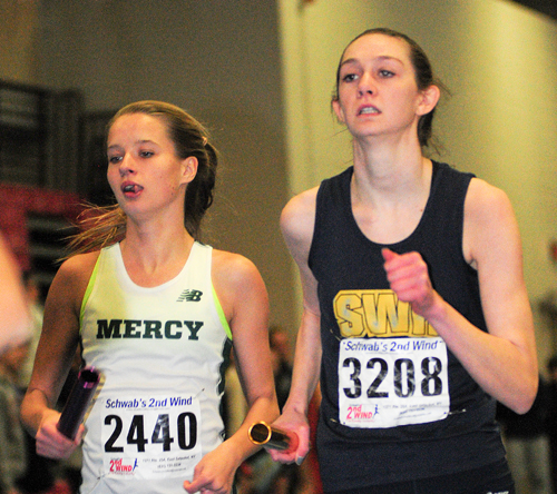 Meg Tuthill of McGann-Mercy races next to Kaitlyn Ohrtman of Shoreham-Wading River in the 4 x 800 relay. (Credit: Bill Landon)