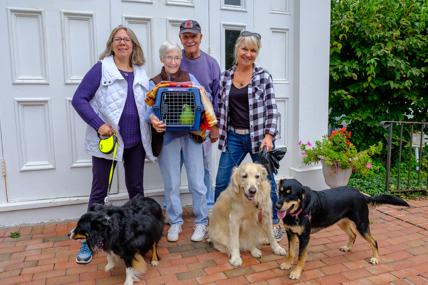 Hawkeye (Parrot), Bailey, Glory and Ranger with their owners Betty and George Capon of Greenport, Holly Weingart of East Marion and Sharon Bogden of Greenport. (Credit: Jeremy Garretson)