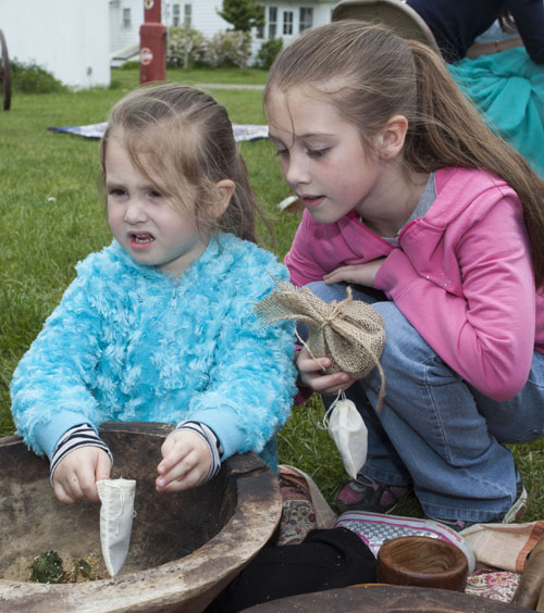Eliana Fratello, 4, and sister Sophia, 8, of East Quogue learn about herbs. (Credit: Katharine Schroeder)