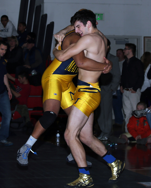 Adam Goode of Mattituck celebrates with team mate Sal Loverde after his victory over William Hamilton of Center Moriches in the 195 Lbs weight class. The Suffolk County Division II wrestling championships were held at Center Moriches High School on Feb. 15, 2014. (Photo credit: Daniel De Mato)
