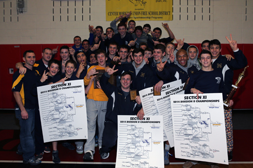 The Mattituck HS Wrestling team celebrates its second Suffolk County Championship in a row. The Suffolk County Division II wrestling championships were held at Center Moriches High School on Feb. 15, 2014. (Photo credit: Daniel DeMato)