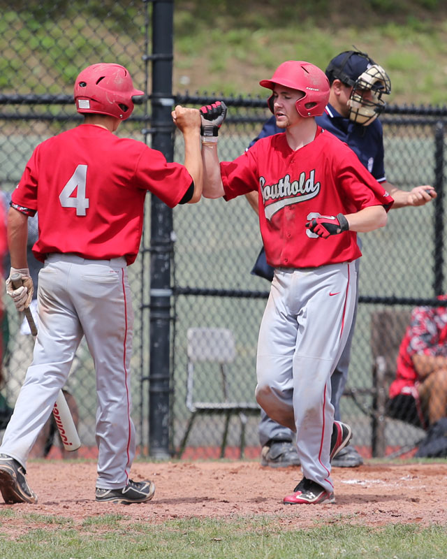 Liam Walker is greeted by Patrick McFarland after crossing the plate. (Credit: Daniel De Mato)