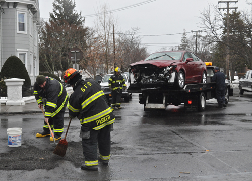 PAUL SQUIRE PHOTO | Greenport firefighters clear the scene of Tuesday afternoon's car crash.