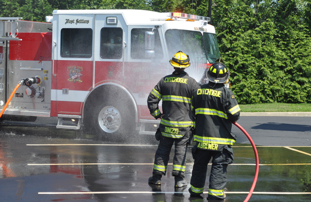 Cutchogue Fire Department members hose down Southold's new pumper. (Credit: Grant Parpan)