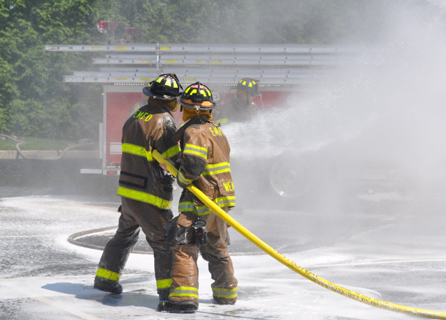 Southold, Cutchogue and East Marion fire department volunteers hosed down Southold's two new trucks and each other Sunday afternoon. (Credit: Grant Parpan)