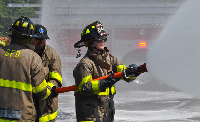Southold, Cutchogue and East Marion fire department volunteers hosed down Southold's two new trucks and each other Sunday afternoon. (Credit: Grant Parpan)