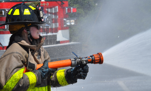 Southold, Cutchogue and East Marion fire department volunteers hosed down Southold's two new trucks and each other Sunday afternoon. (Credit: Grant Parpan)
