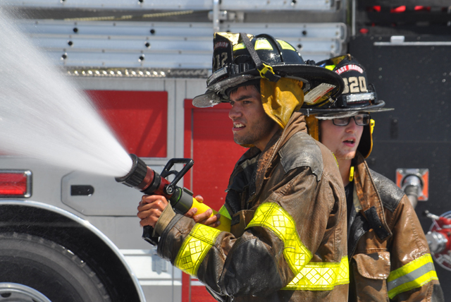 Southold, Cutchogue and East Marion fire department volunteers hosed down Southold's two new trucks and each other Sunday afternoon. (Credit: Grant Parpan)