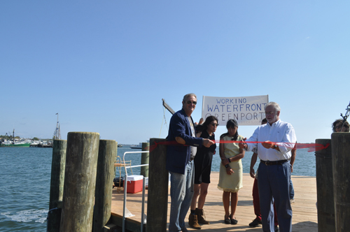 Congressman Tim Bishop cuts the ribbon at Widow's Hole Oysters on Saturday morning. (Credit: Joseph Pinciaro)