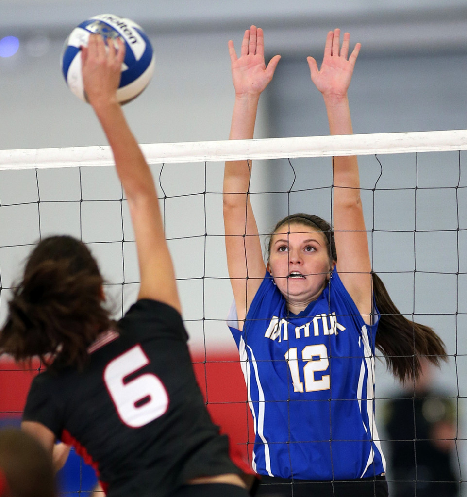 Senior middle blocker Skyler Grathwohl with a block.