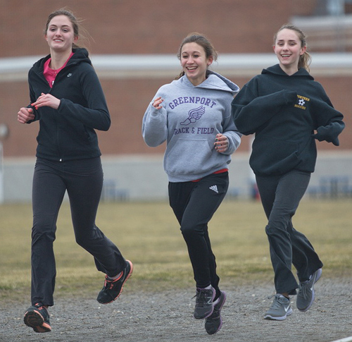 GARRET MEADE PHOTO | From left, Greenport's Megan Murray, Marina DeLuca and Emma Marshall hit the track during practice.