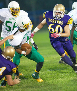 GARRET MEADE PHOTO | Greenport/Southold/Mattituck's Codey Fisher pulled on Wyandanch quarterback Taquan Brooks' jersey while Jon Bakowski (60) closes in.