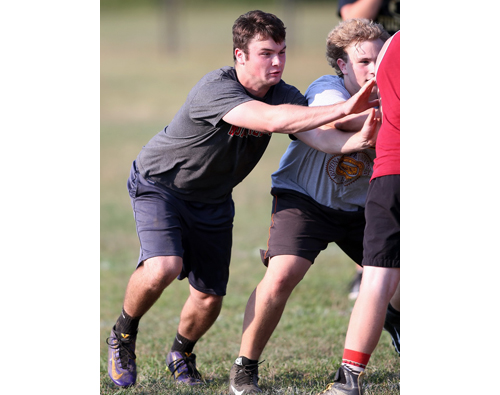 Liam Finnegan, a senior lineman working on a blocking scheme, during a Greenport/Southold/Mattituck practice. (Credit: Garret Meade, file)
