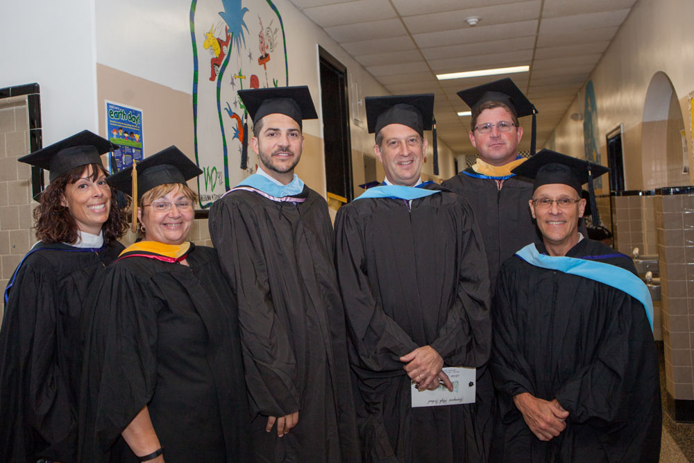 Administrators and staff pose before the ceremony.