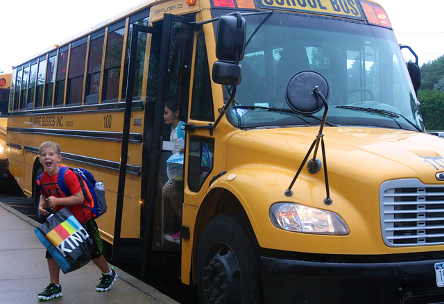 Third grader Matt McGunnigle showed his excitement as he stepped off the bus. He said he couldn't wait to see his friends and learn.