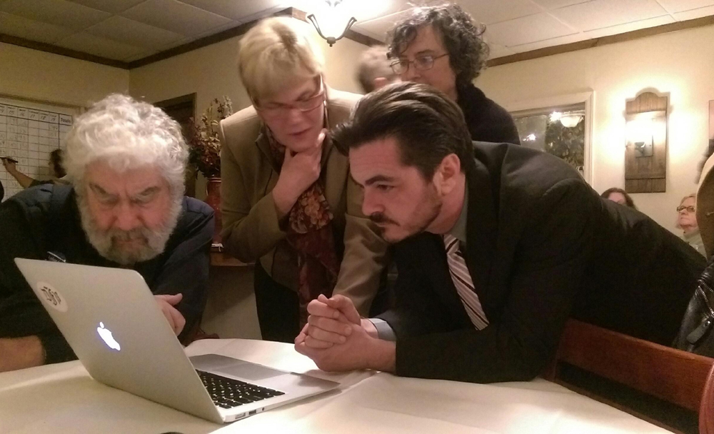 Town supervisor candidate Damon Rallis looks at the results Tuesday night. (Credit: Chris Lisinski)