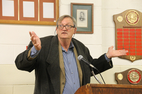 PAUL SQUIRE PHOTO | Michael Osinski, owner of Widow's Hole Oyster Company, responds to shouts from the crowd during a public hearing at the Greenport Village board meeting Monday night.