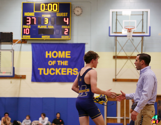 Mattituck coach Cory Dolson congratulates Luke Bokina after his 10-2 major decision. (Credit: Joe Werkmeister)