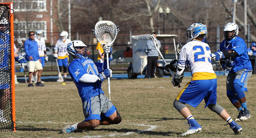Mattituck/Greenport/Southold's Tim Schmidt scoring a goal against Riverhead goalie John Roca. (Credit: Daniel De Mato)