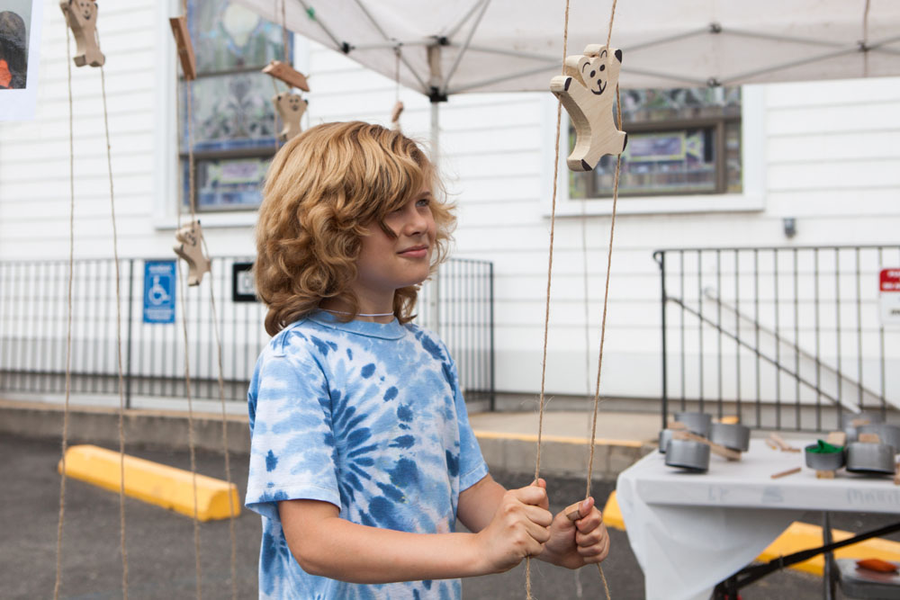 Kent Robins, 9, of Cutchogue plays with traditional toys.