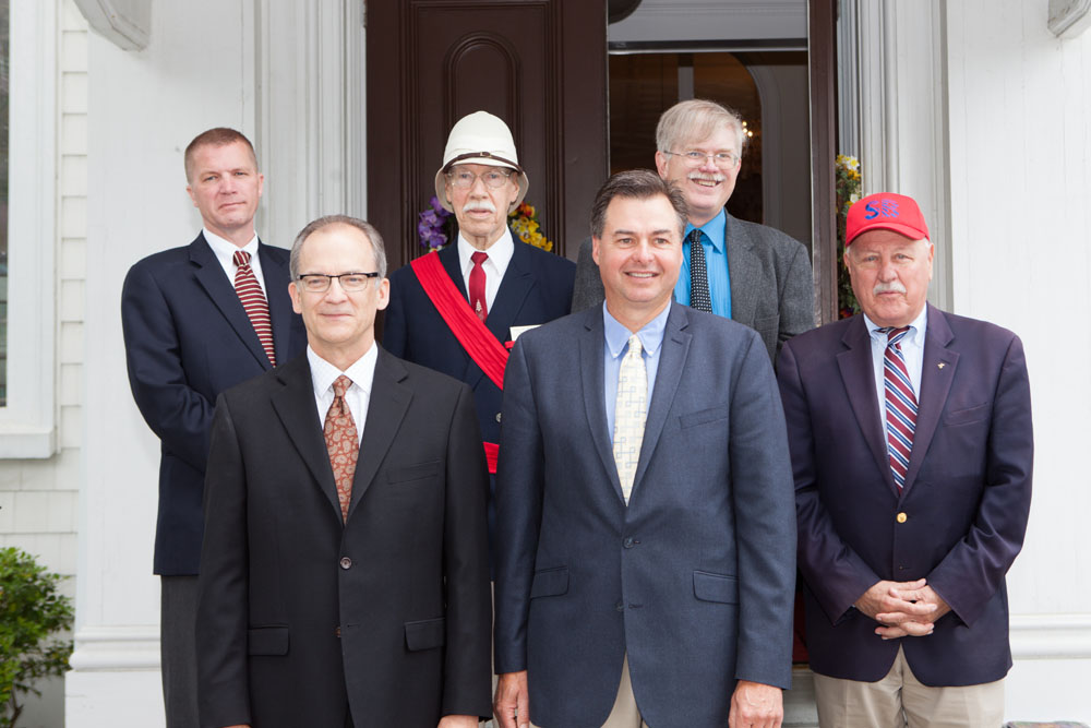 Dignitaries pose on the church steps.