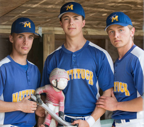 From left, Joe Tardif, Jon Dwyer and Will Gildersleeve with Optimus, a hockey gnome that has served as Mattituck's good-luck charm this season. (Credit: Katharine Schroeder)