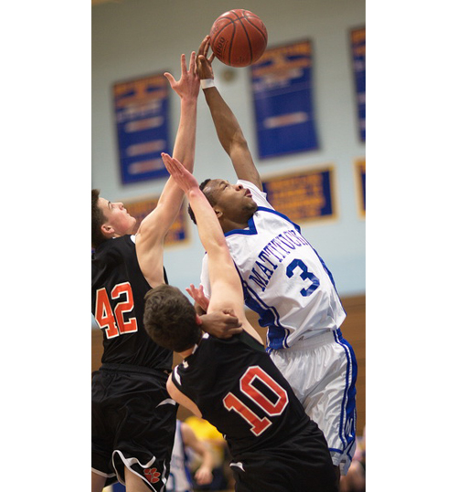 GARRET MEADE PHOTO | Mattituck's Eugene Allen reaching for a rebound in the vicinity of Babylon's Raymond Wardell (42) and Alec Zamet (10).