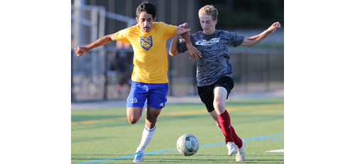 Mattituck's Kaan Ilgin, left, fights for possession of the ball with Southold's Shayne Johnson. (Credit: Daniel De Mato)