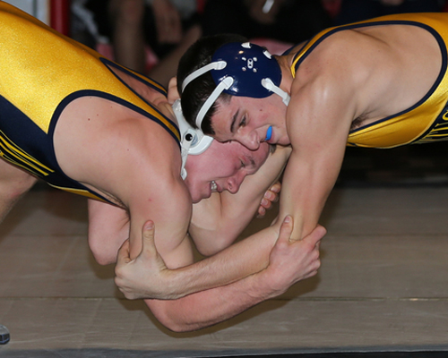 DANIEL DE MATO PHOTO | Mattituck/Greenport senior Tomasz Filipkowski, left, going head to head with teammate Sal Loverde in the 170-pound final. Filipkowski won a third straight county title.