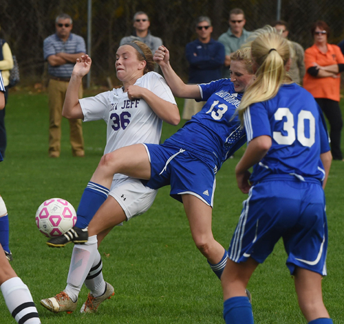 Mattituck senior Nikki Zurawski (13) fights for position against Port Jefferson's Olivia Love. (Credit: Robert O'Rourk)