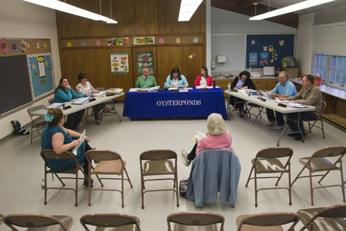 here were two audience members at Tuesday night’s Oysterponds school board meeting in Orient. Most Board of Education meetings on the North Fork have low turnouts. (Credit: Paul Squire, file)