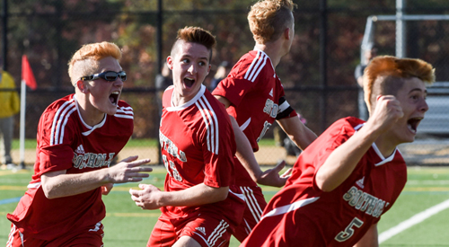 Sean Moran (5) pumps his fist after scoring in sudden-victory overtime to bring Southold a second straight county title. Joining in the celebration are, from left, Ryan DiGregorio, Walker Sutton and Shayne Johnson. (Credit: Robert O'Rourk)
