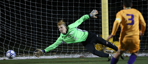 Rhinebeck's Eric Rodriguez knocks the winning penalty kick beyond the reach of Southold goalkeeper John Charles Funke. (Credit: Garret Meade)