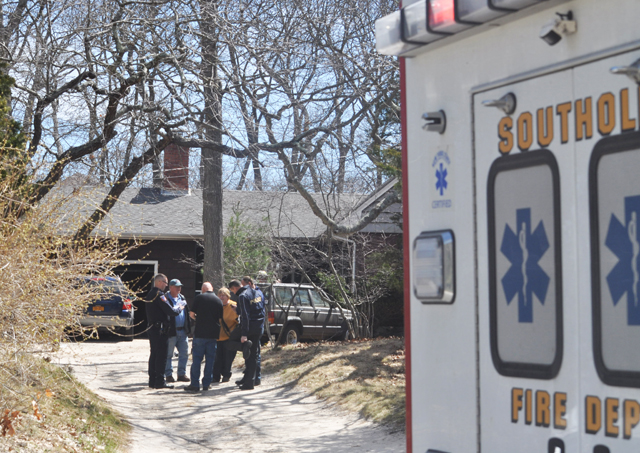 Southold fire chief Peggy Killian meets with Suffolk arson squad investigators as they arrive on the scene of a fatal house fire in Southold Wednesday. (Credit: Grant Parpan photos)