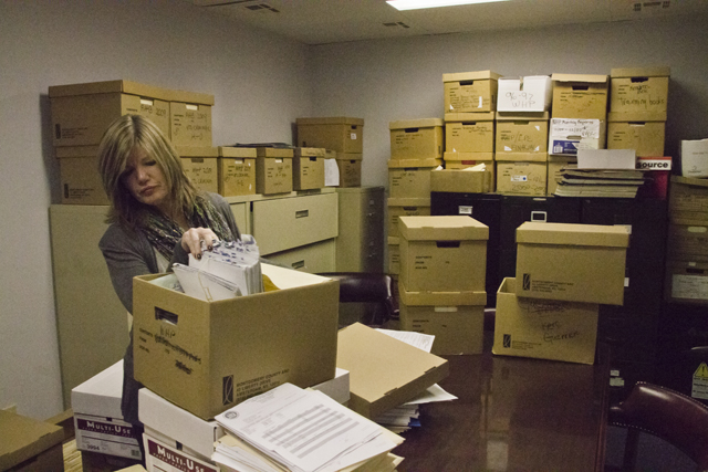 Southold Town Justice Court Director Leanne Reilly thumbs through files in the court's conference room. (Credit: Paul Squire)
