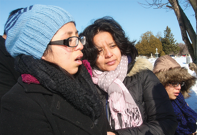 Guadelupe Mendoza (left) and her sister, Giselle (right), are comforted by their cousin Luz Contrearas of Brooklyn. (Credit: Barbaraellen Koch)