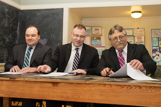 Greenport Village Trustee Doug Roberts (from left), deputy mayor Jack Martilotta and Mayor George Hubbard get down to business after being sworn in during Monday evening's reorganizational meeting. (Credit: Paul Squire)